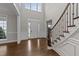 Bright foyer with hardwood floors, high ceilings, and elegant staircase at 228 Cloverdale Rd, Apex, NC 27523