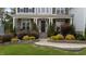 Close-up of inviting home with stone accents, manicured landscaping, and covered front porch at 228 Cloverdale Rd, Apex, NC 27523
