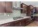Gourmet kitchen with stainless steel range hood, built-in oven, and dark wood cabinetry at 228 Cloverdale Rd, Apex, NC 27523