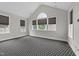 Bright living room featuring large windows, vaulted ceiling, and neutral color scheme at 228 Cloverdale Rd, Apex, NC 27523