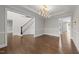 Elegant entryway featuring hardwood floors, staircase, and decorative trim at 228 Cloverdale Rd, Apex, NC 27523