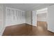 Office with hardwood floors, built-in shelving, and a doorway to another bright room at 228 Cloverdale Rd, Apex, NC 27523