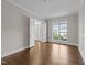 Bright, empty room with hardwood floors and french doors leading to another room at 228 Cloverdale Rd, Apex, NC 27523