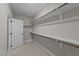 Bright walk-in closet with a door and ample shelving space at 228 Cloverdale Rd, Apex, NC 27523