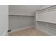Walk-in closet offering ample storage space with multiple shelves and rods at 228 Cloverdale Rd, Apex, NC 27523