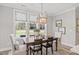 Well-lit dining area features a wooden table and large windows offering a view of the backyard at 23 W Victoria Ridge Dr # 33, Selma, NC 27576