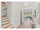 Entry hallway view of staircase and living room, showcasing the home's bright and open layout at 23 W Victoria Ridge Dr # 33, Selma, NC 27576