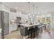 Modern kitchen features stainless steel appliances, a center island with bar seating, and bright natural light at 23 W Victoria Ridge Dr # 33, Selma, NC 27576