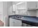 Bright kitchen with double sink, dishwasher, and serving hatch to adjacent room at 236 Katie Dr, Rocky Mount, NC 27803