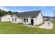 Backyard with grass, a black back door, and vinyl siding at 236 Katie Dr, Rocky Mount, NC 27803