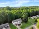 Aerial view of a landscaped home with a large yard, driveway, and surrounding trees at 240 Carrington Ave, Franklinton, NC 27525