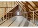 Large unfinished attic with exposed rafters, plywood subfloor, and a single window at 240 Carrington Ave, Franklinton, NC 27525