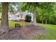 Spacious backyard featuring a gentle slope, mature trees, and comfortable outdoor seating at 240 Carrington Ave, Franklinton, NC 27525