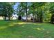 Expansive backyard with mature trees and lush green lawn at 240 Carrington Ave, Franklinton, NC 27525
