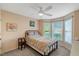 This cozy bedroom has a ceiling fan, a decorative painting, and natural light from the windows at 240 Carrington Ave, Franklinton, NC 27525