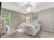 Bright bedroom with a queen-sized bed, soft colors, and large windows with natural light at 240 Carrington Ave, Franklinton, NC 27525
