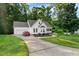 One-story home with attached garage, long driveway, manicured lawn, and a covered front porch at 240 Carrington Ave, Franklinton, NC 27525