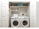Practical laundry room features a washer, a dryer, and convenient shelving at 240 Carrington Ave, Franklinton, NC 27525