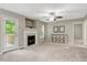 Bright living room with fireplace and outdoor access, featuring neutral decor and ample natural light at 240 Carrington Ave, Franklinton, NC 27525