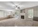 Spacious living room with a fireplace, ceiling fan, and access to the backyard at 240 Carrington Ave, Franklinton, NC 27525