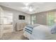 Neutral main bedroom features a ceiling fan, TV, and lots of natural light at 240 Carrington Ave, Franklinton, NC 27525