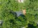 Aerial view of a home's backyard with landscaping and mature trees at 2504 W Club Blvd, Durham, NC 27705
