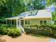 Charming backyard with mature trees, a screened-in porch, and verdant landscaping at 2504 W Club Blvd, Durham, NC 27705