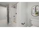 Neat bathroom featuring a shower-tub combo, modern fixtures, and a circular mirror at 2504 W Club Blvd, Durham, NC 27705