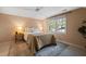 Charming bedroom with two windows, ceiling fan, and warm lighting at 2504 W Club Blvd, Durham, NC 27705