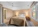 Cozy bedroom featuring neutral walls, ceiling fan, plush bedding, and ample natural light at 2504 W Club Blvd, Durham, NC 27705