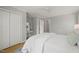 Spacious bedroom featuring a ceiling fan, and ample closet space with white bedding, and a decorative rug at 2504 W Club Blvd, Durham, NC 27705