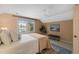 Bright bedroom with a large window, light-colored walls, a ceiling fan, and a comfortable bed at 2504 W Club Blvd, Durham, NC 27705