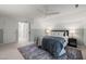 Spacious bedroom featuring a ceiling fan, a wide doorway, soft carpet, and a comfy bed at 2504 W Club Blvd, Durham, NC 27705