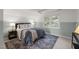 Comfortable bedroom showcasing a ceiling fan, large window, soft lighting, and stylish decor at 2504 W Club Blvd, Durham, NC 27705
