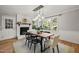 Bright dining area with a fireplace and large windows overlooking the yard at 2504 W Club Blvd, Durham, NC 27705