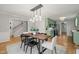 Elegant dining room with a modern light fixture and adjacent kitchen at 2504 W Club Blvd, Durham, NC 27705