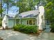 View of a home's front exterior with tidy landscaping, a garage, and lush greenery at 2504 W Club Blvd, Durham, NC 27705