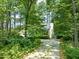 Single-Gathering house nestled among tall trees featuring well-kept landscaping at 2504 W Club Blvd, Durham, NC 27705
