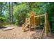 Wood playset nestled in a leafy backyard setting complete with a swing and sandbox at 2504 W Club Blvd, Durham, NC 27705