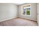 Bedroom features neutral walls, carpeted floors, and a large window at 262 Salt Cedar Ln, Chapel Hill, NC 27516