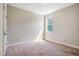 Carpeted bedroom features a neutral color scheme and a bright window at 262 Salt Cedar Ln, Chapel Hill, NC 27516