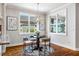 Cozy breakfast nook with round table, designer light fixture, windows, and hardwood floors at 262 Salt Cedar Ln, Chapel Hill, NC 27516