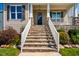 Inviting stone staircase leads up to the charming front porch, providing a warm entrance at 262 Salt Cedar Ln, Chapel Hill, NC 27516