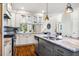 Kitchen boasts a central island with sink, granite countertops, stainless steel appliances, and glass-front upper cabinets at 262 Salt Cedar Ln, Chapel Hill, NC 27516
