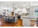Spacious kitchen features white cabinets, stainless steel appliances, granite countertops and a kitchen island with barstool seating at 262 Salt Cedar Ln, Chapel Hill, NC 27516