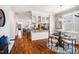 Spacious, open floor plan view of the dining nook and kitchen with hardwoods at 262 Salt Cedar Ln, Chapel Hill, NC 27516