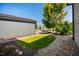 Charming side yard with lush green grass, landscaping, and a stone pathway leading to the property at 262 Salt Cedar Ln, Chapel Hill, NC 27516