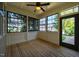 Relaxing sunroom with wood floors and large windows for natural light and views of the outdoors at 262 Salt Cedar Ln, Chapel Hill, NC 27516