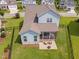 Aerial view of backyard with a screened porch, patio with firepit, and fenced yard at 2806 High Plains Dr, Fuquay Varina, NC 27526