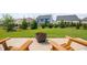 Backyard with patio with a firepit, lush green grass, and manicured landscaping at 2806 High Plains Dr, Fuquay Varina, NC 27526